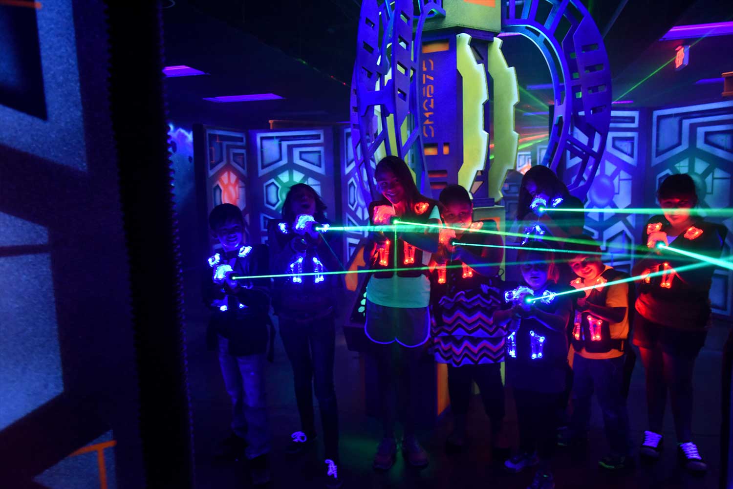 Kids playing lazer tag in an indoor course